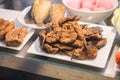 Close-fried crispy fish pieces on a plate heaped with old wooden