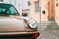 Close Front View Of Porsche 930 Car Parked In Old Narrow Street.