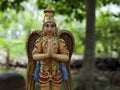 Close front view of standing Garuda idol in Natural arch rock garden in Tirumala