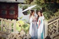 Close girlfriends bestie in Chinese traditional ancient costume in a garden Royalty Free Stock Photo