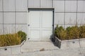 Close grey door with aluminium or steel wall