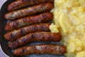 Close grilled Nuremberg sausages with potato Royalty Free Stock Photo