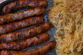 Close grilled Nuremberg sausages with sauerkraut Royalty Free Stock Photo