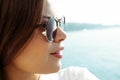 Close headshot of pretty female woman middle east face with sunglasses. Brunette macro look right face by sea in Istanbul. Tourist