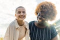 Close interracial friendship. Delighted happy mixed race girls smiling and embracing. Value of different cultures