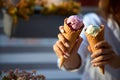 Close isolated view of two ice cream cones in hand of women friends standing outdoors. No face, copyspace for designers Royalty Free Stock Photo