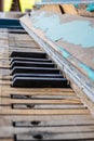 A close of the keys on an old, weathered piano with selective focus on some