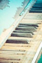 A close of the keys on an old, weathered piano with selective focus on some