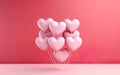 Close knit bunch of pastel pink heart shaped balloons tied together