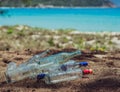 Close landfill old dirty transparent discarded empty glass alcohol drinks bottles trash on ground forest nature sea park