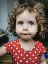 Close of Little Brazilian girl looking to the side outdoors