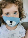 Close of Little Brazilian girl using mask on quarantine