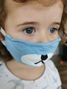 Close of Little Brazilian girl using mask on quarantine