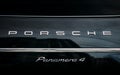 Close Logo Logotype Sign Of Porsche On Black Background. Black porsche panamera 4