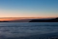 Close long exposure shot of evening mountain silhouettes, sea and clouds in Picnic Point area