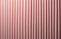 Close macro view of soft pink corduroy textile with vertical ribbed pattern. Delicate fabric texture creates striped surface for Royalty Free Stock Photo