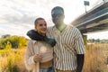 Close mixed race friendship. Young happy African man and caucasian woman hugging and smiling, enjoying a sunny summer