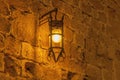 Close old light at night hanging on a medieval street fortress