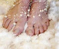 Close and personal view of beautifully manicured toes topped with string pearls Royalty Free Stock Photo