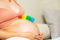 Pregnant woman with color blocks making girl word