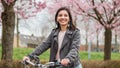 Close portrait of beautiful multi-ethnic Turkish woman 20-29s riding a bike in the city street Royalty Free Stock Photo