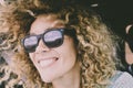 Close portrait of beautiful young adult caucasian cheerful happy woman smile and look at the road reflected on sunglasses during a