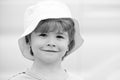 Close portrait of a boy with long hair in hat. Happy little child smiling. Adorable baby having fun. Carefree child Royalty Free Stock Photo