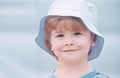 Close portrait of a boy with long hair in hat. Happy little child smiling. Adorable baby having fun. Carefree child Royalty Free Stock Photo