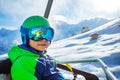 Close portrait of a boy with ski helmet and mask on chairlift Royalty Free Stock Photo