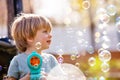 Close portrait of a cute boy play with soap bubble gun Royalty Free Stock Photo