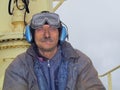 Close portrait of dirty worker seaman welder with lively look on board of oil tanker