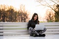 Close portrait of gorgeous dark-hair woman student using laptop computer at campus, charming female teenager studying on Royalty Free Stock Photo