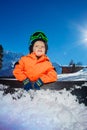 Close portrait of a happy little snowboarder boy on ski track Royalty Free Stock Photo