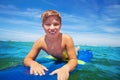 Close portrait of happy surfing boy on surfboard Royalty Free Stock Photo