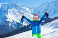 Boy with Santa hat and big smile stand in snow lift up hands Royalty Free Stock Photo