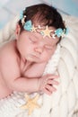 Close portrait of a sleeping newborn girl in the maritime hoop of starfish and pearls