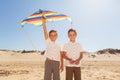 Portrait of two twin brothers with kite on a beach Royalty Free Stock Photo