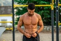 Close portrait of young Latin man without a shirt and black pants and mask training