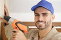 close portrait young tradesman using drill Royalty Free Stock Photo