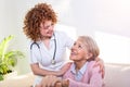 Close positive relationship between senior patient and caregiver. Happy senior woman talking to a friendly caregiver. Young pretty