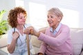 Close positive relationship between senior patient and caregiver. Happy senior woman talking to a friendly caregiver. Young pretty