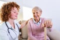 Close positive relationship between senior patient and caregiver. Happy senior woman talking to a friendly caregiver. Young pretty Royalty Free Stock Photo