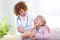 Close positive relationship between senior patient and caregiver. Happy senior woman talking to a friendly caregiver. Young pretty