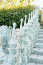 Close of railing of old baroque stairs, outdoors. Stairs made of stone, Alley in beautiful garden with flowers and trees around. Royalty Free Stock Photo