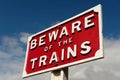 Close up of railway sign reading BEWARE OF THE TRAINS.