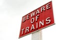 Close up of railway sign reading BEWARE OF THE TRAINS.