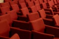 close rows of red armchairs