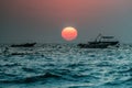 Close Scenic Sunset on beach in South Asia? Fishing boats on horizon line in Indian Ocean. Clear evening sky beautifully