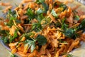 Close shoot of fresh looking carrot salad on plate under beautiful sunlight