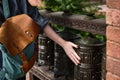 Close shot from the back of a backpack and female hand on a Mani prayer wheel, focus on a backpack